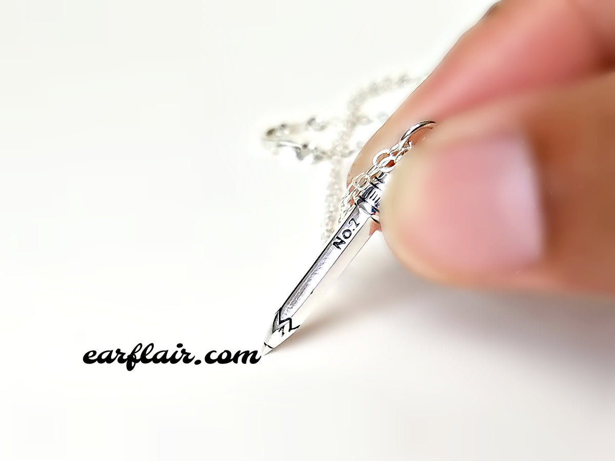 Sterling silver pencil charm necklace.